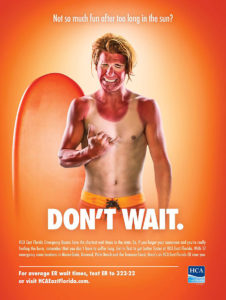A terribly sunburnt man cringing